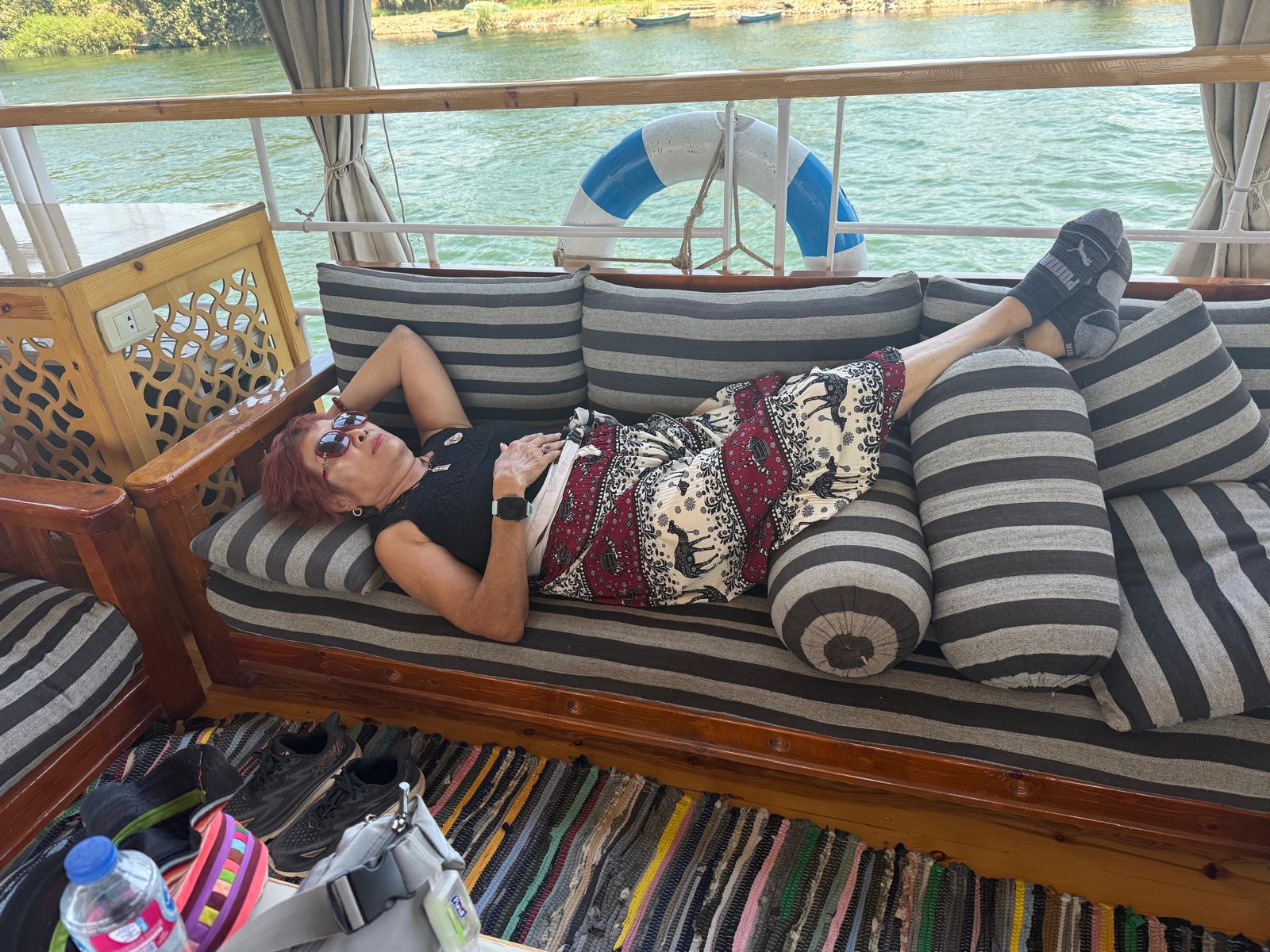 Guest relaxing aboard a Nile dahabiya